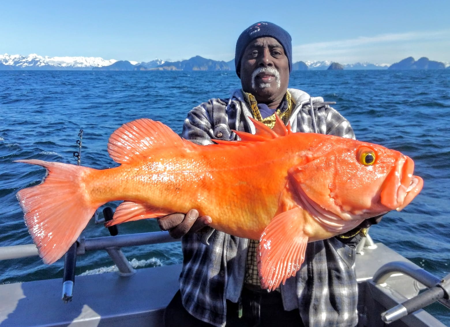 a man holding a rockfish